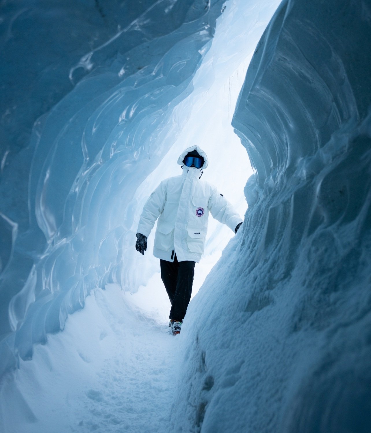 Guest visiting the inside of a naturally forming ice tunnel in Antarctica