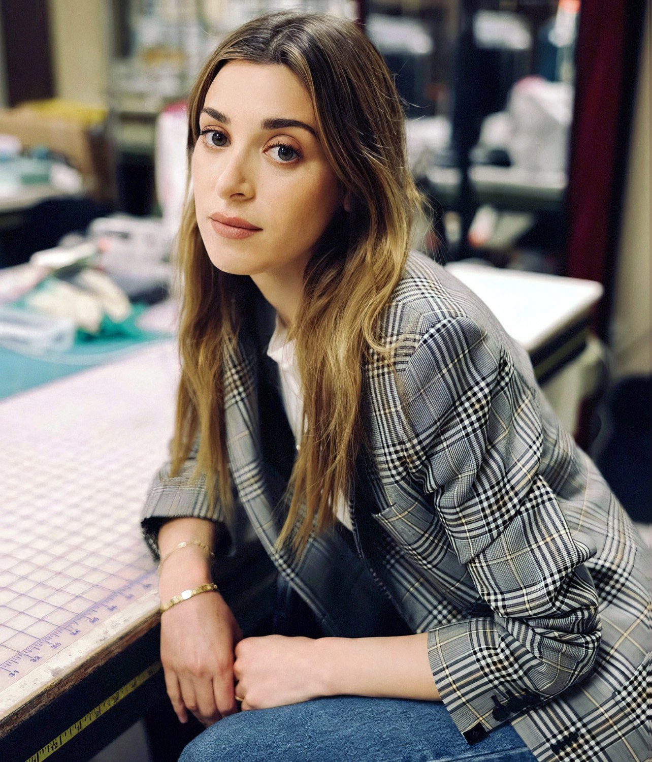 Photo of stylist Jamie Mizrahi wearing a plaid blazer