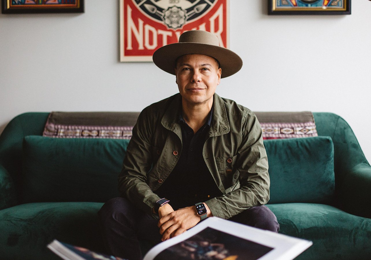 Portrait of Luis Vargas posing wearing a hat and green jacket