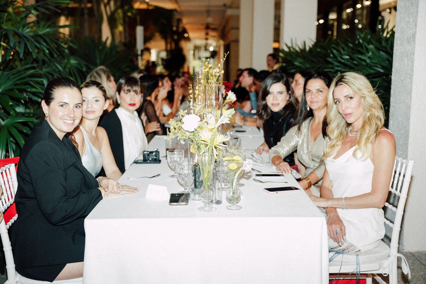A variety of images showcasing the Bal Harbour Shops x Ferragamo dinner. Images include guests in attendance wearing full Ferragamo looks and enjoying dinner