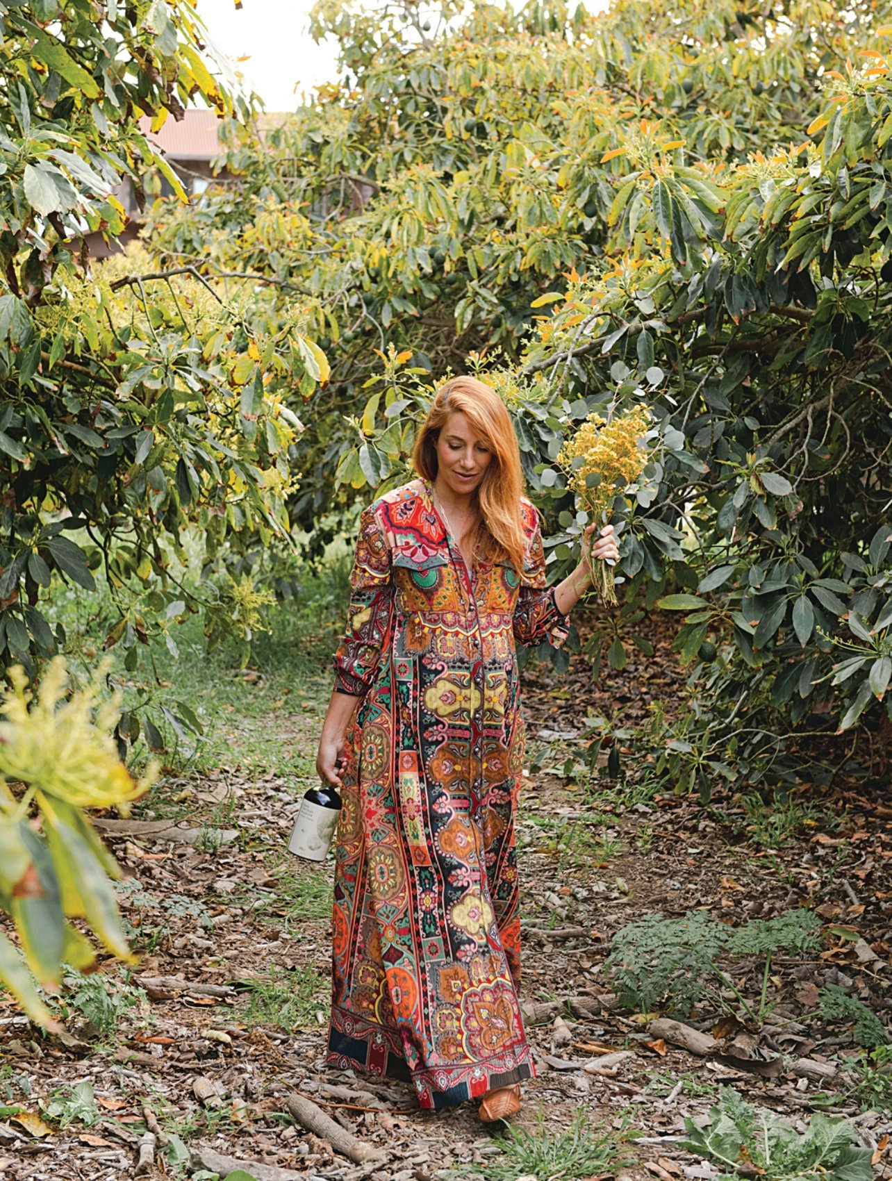 Portrait of Camilla Marcus carrying flowers in nature by photographer Benjamin Rosser