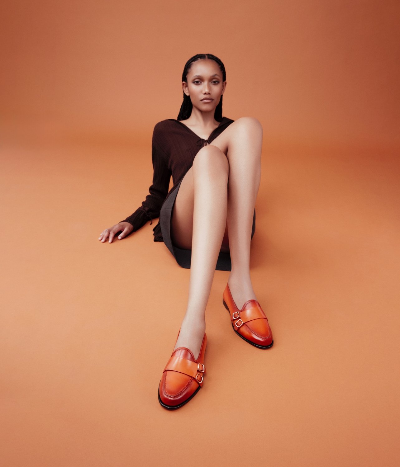 Model for Santoni modeling the new Andrea loafer in orange with gold hardware