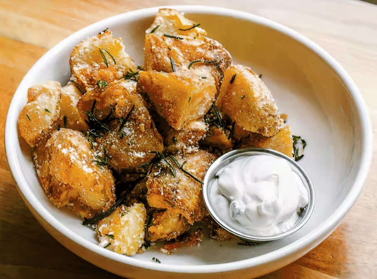 Crispy potatoes served with mizithra and scallion crema from Aba at Bal Harbour Shops