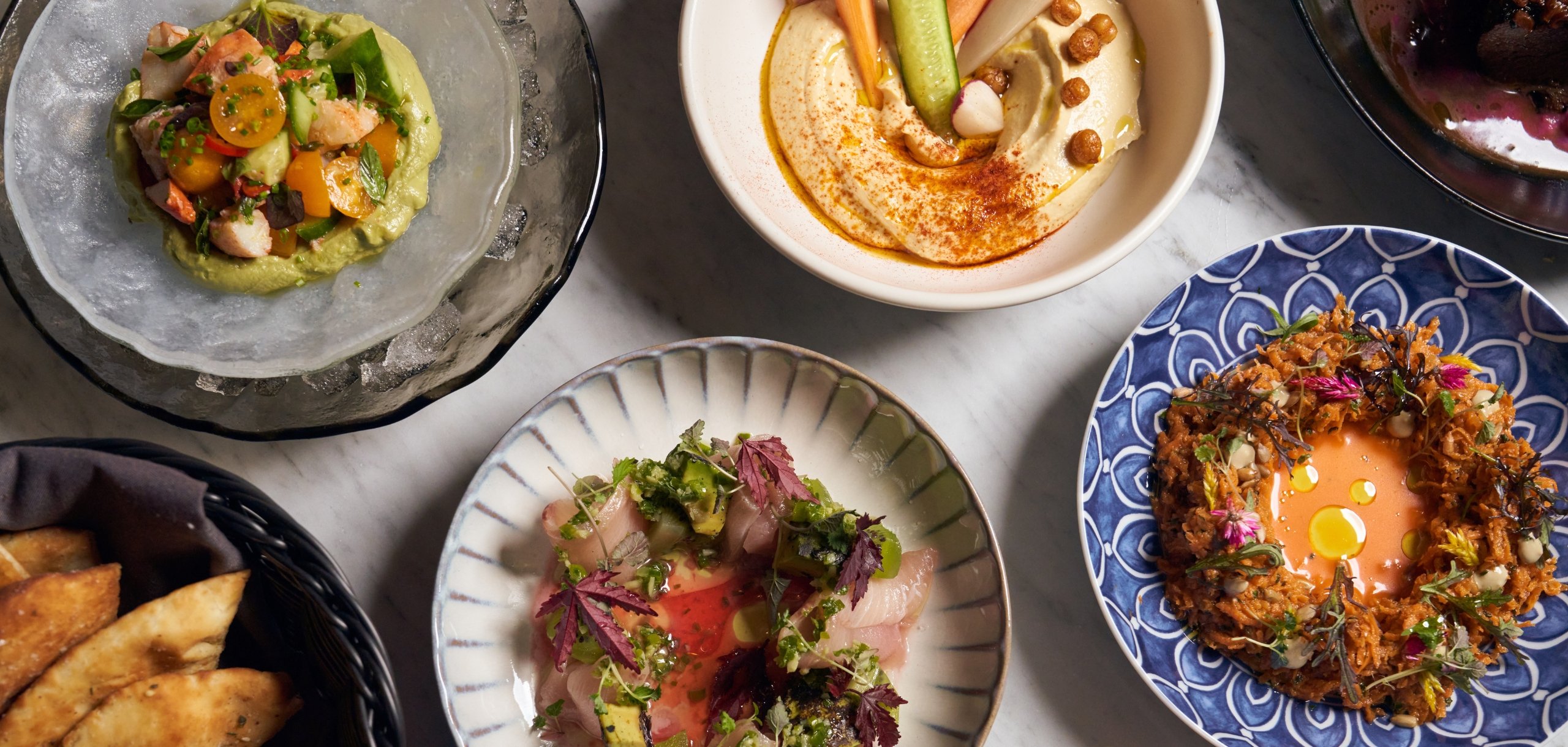 Image of a spread of dishes from Aba at Bal Harbour Shops