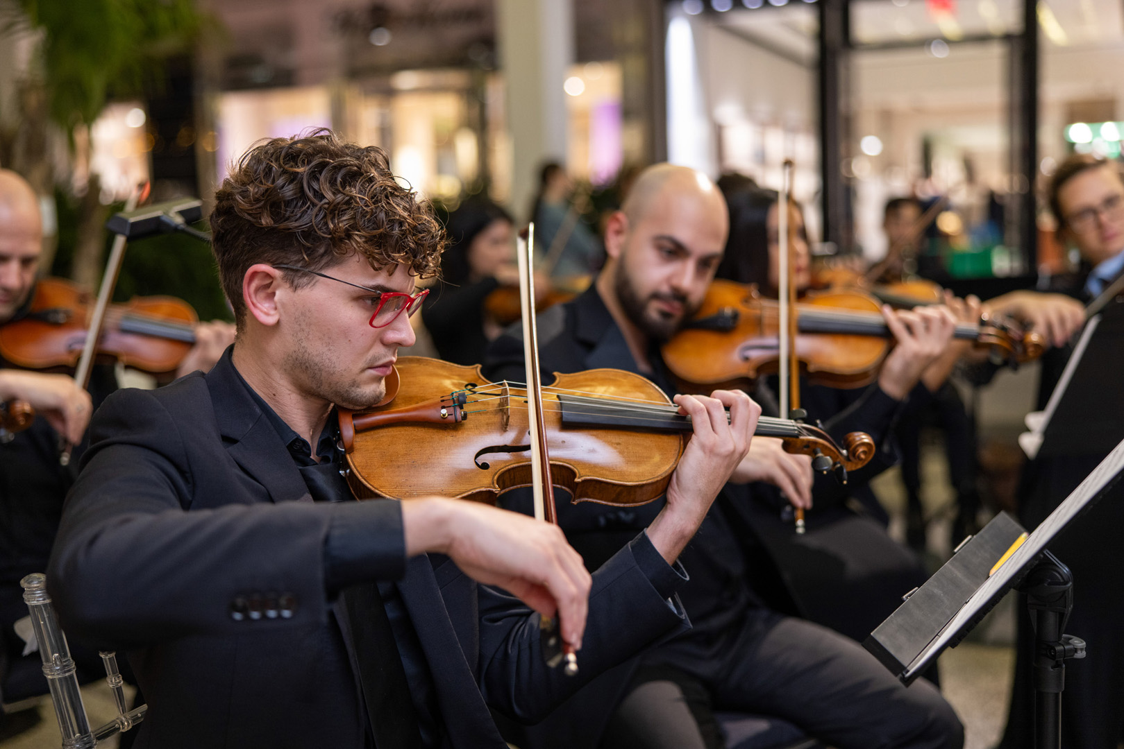 Violinist performing at the holiday event