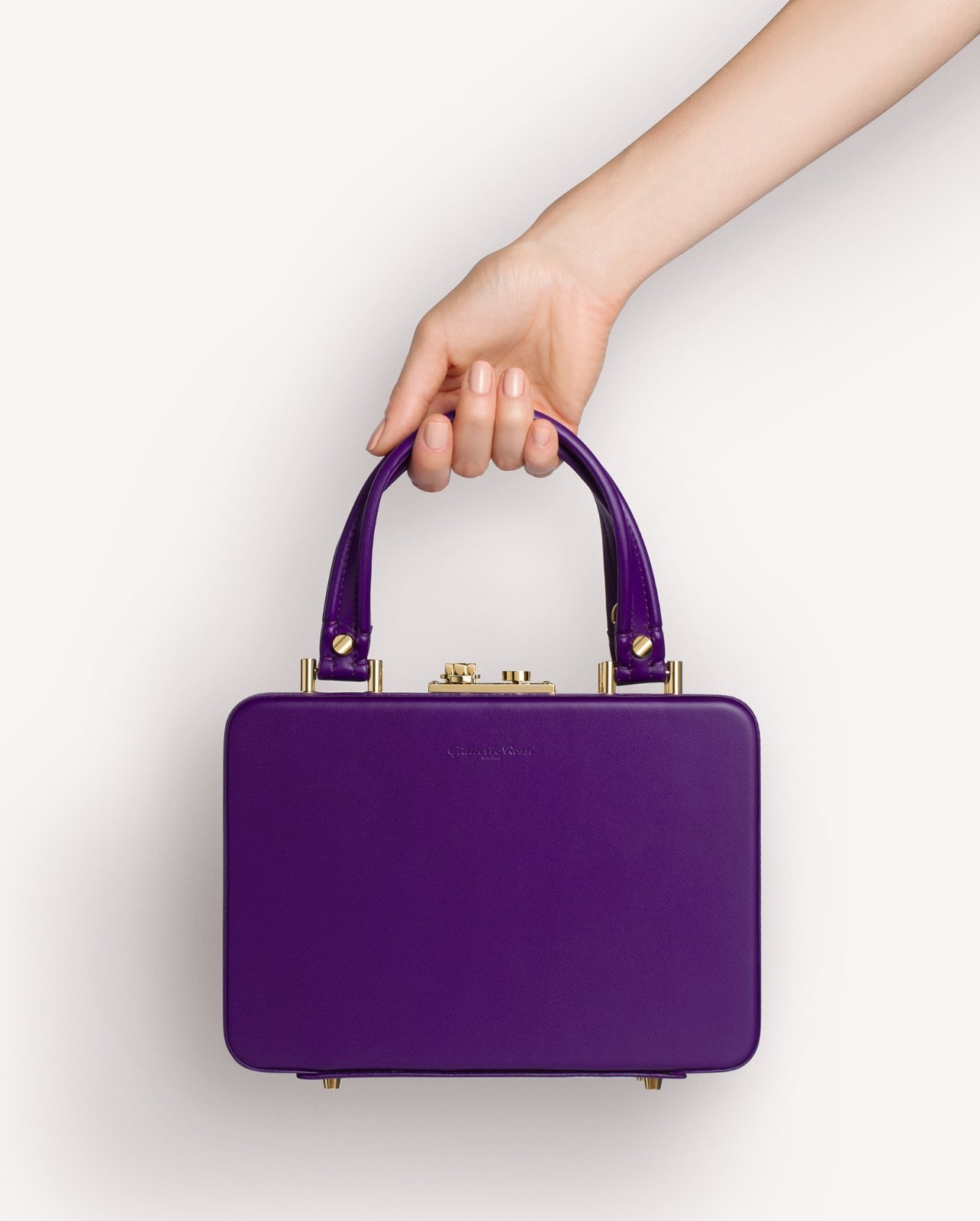 Image of model carrying the new Gianvito Rossi Valì bag in purple