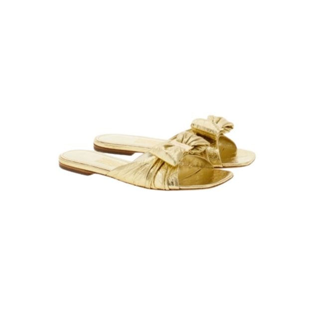 Gold padded slide sandals with bow detailing at the top