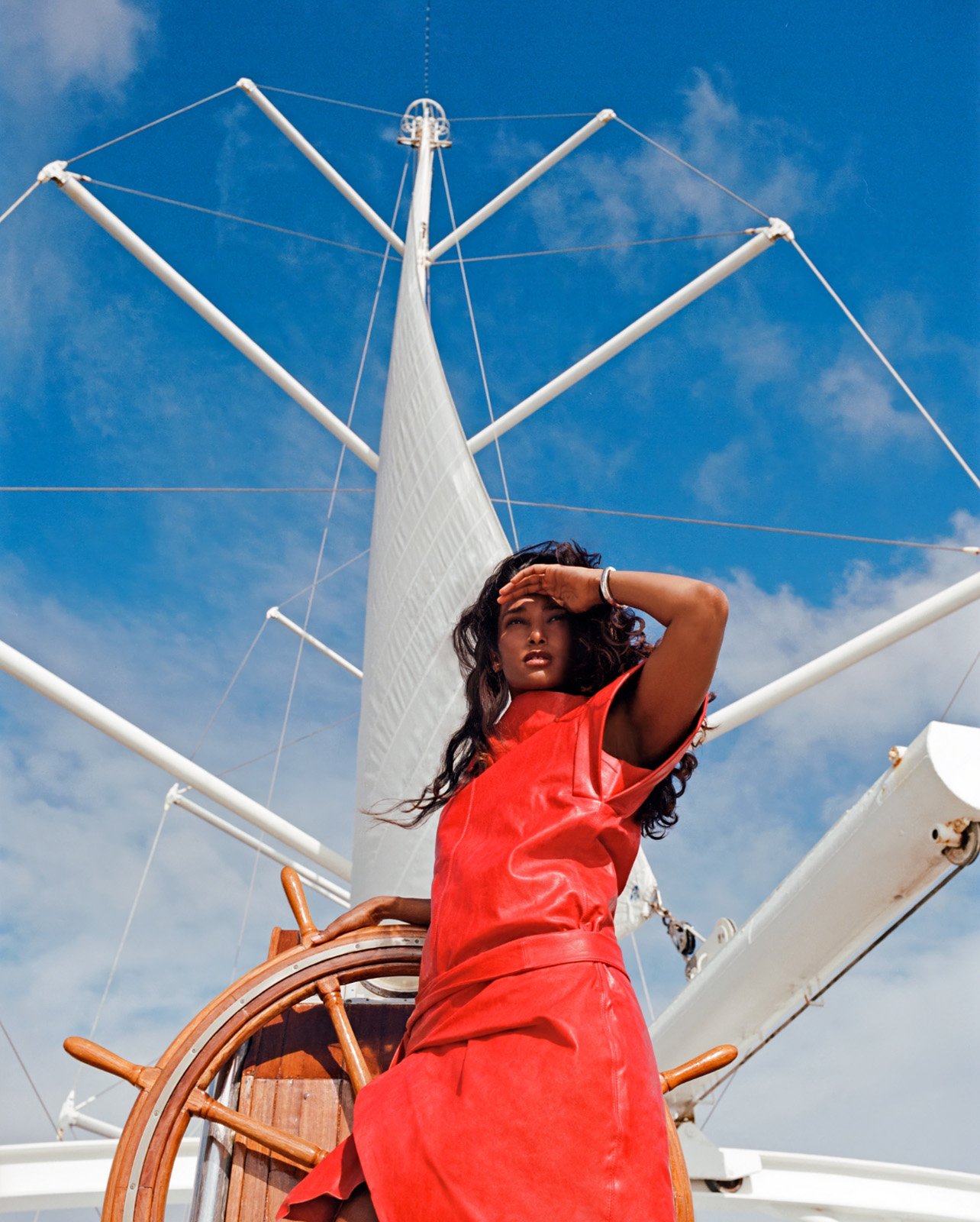 Nidhi Sunil posing in an Isabel Marant red mini dress