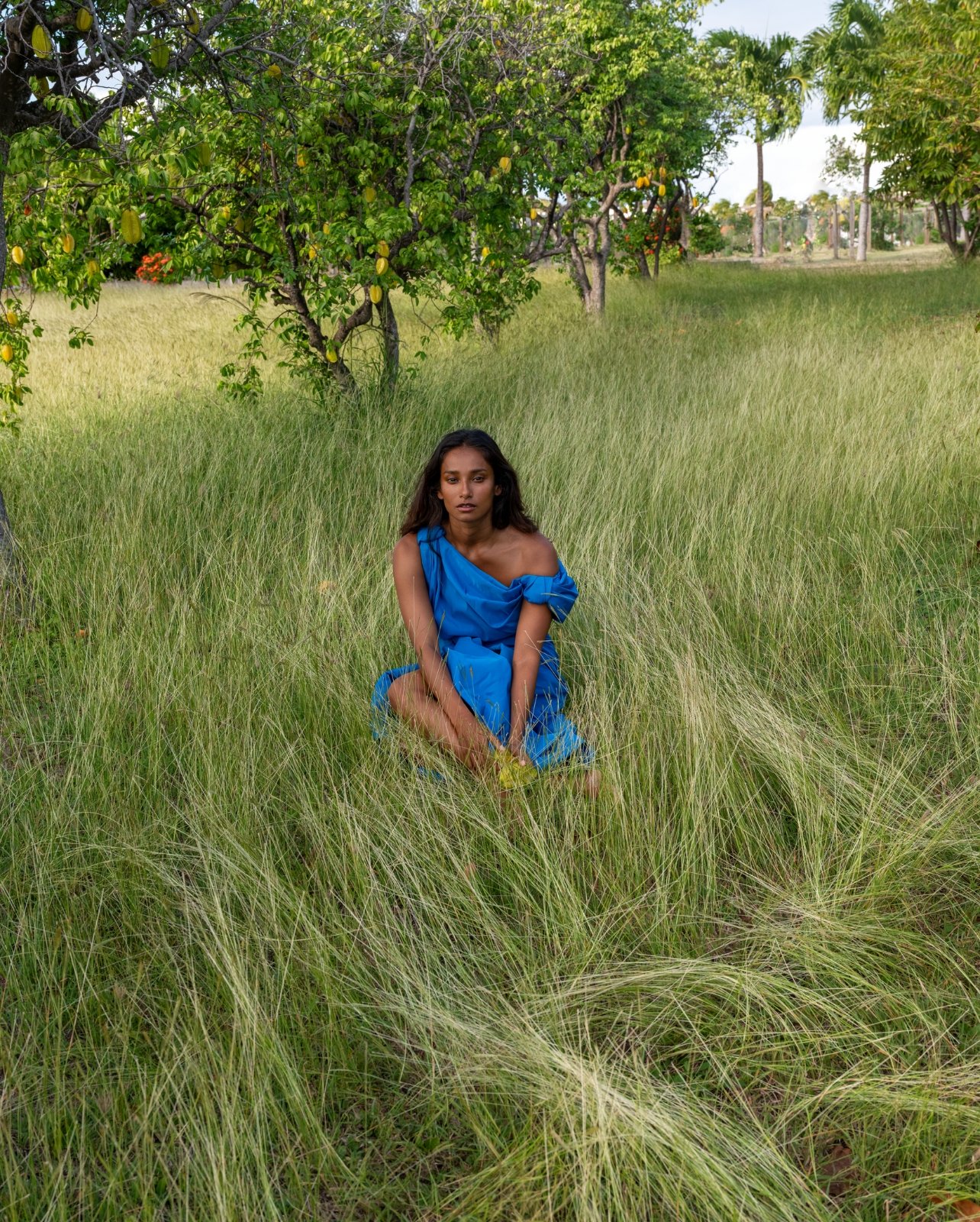 Nidhi Sunil posing in Alexander McQueen blue dress