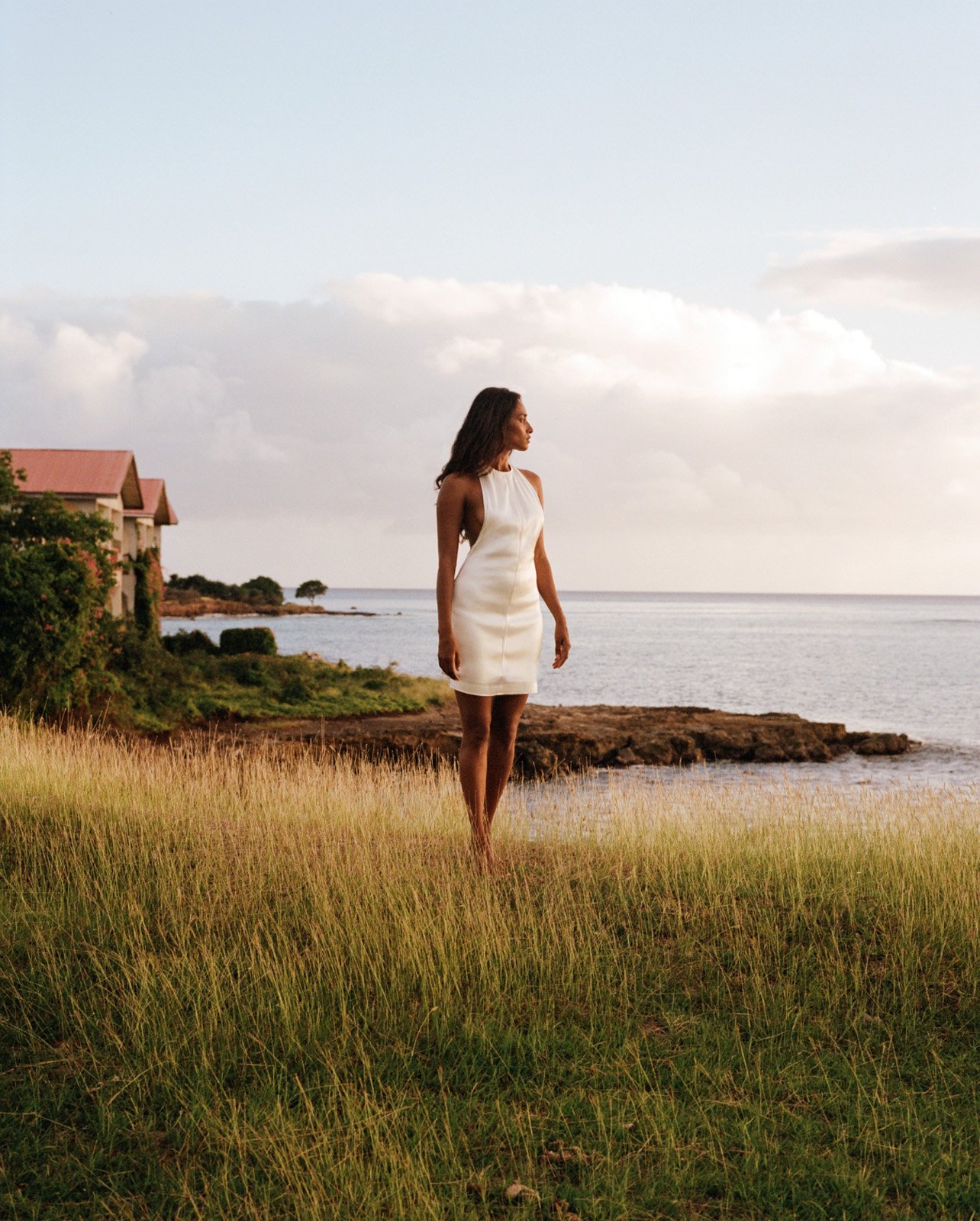 Nidhi Sunil posing in Saint Laurent by Anthony Vaccarello cream dress