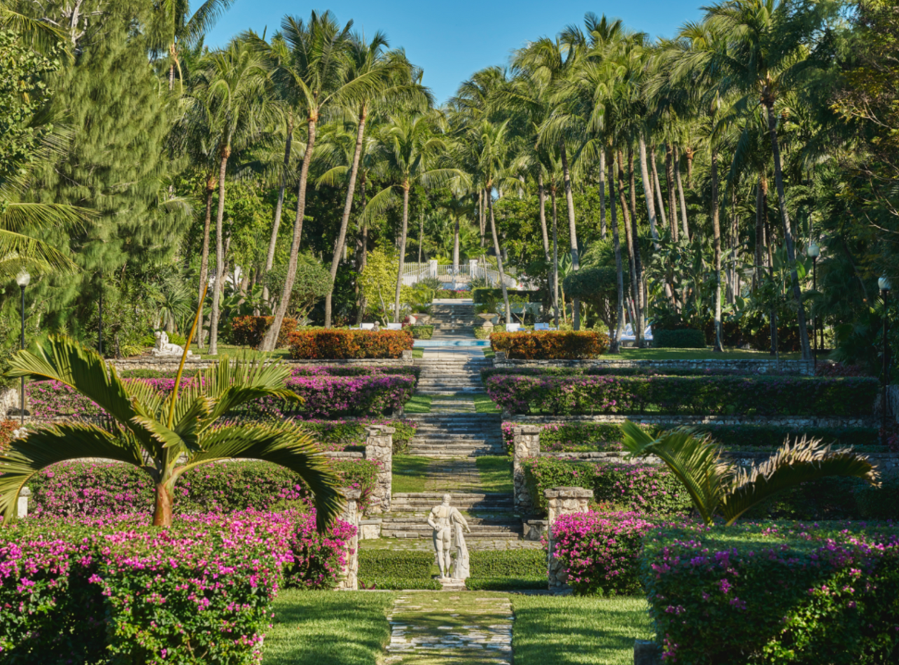 Four Seasons garden filled with greenery and purple and orange flowers