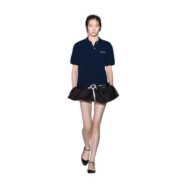Model in Miu Miu Navy Collared Shirt and Black Silk mini skirt on the runway from Spring Summer Collection