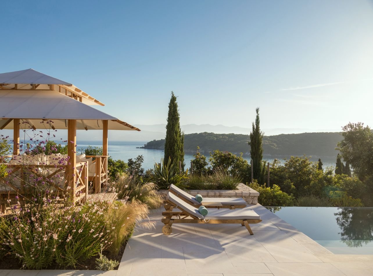 Villa Pool in Ionian Islan with covered seating area and lounge chairs