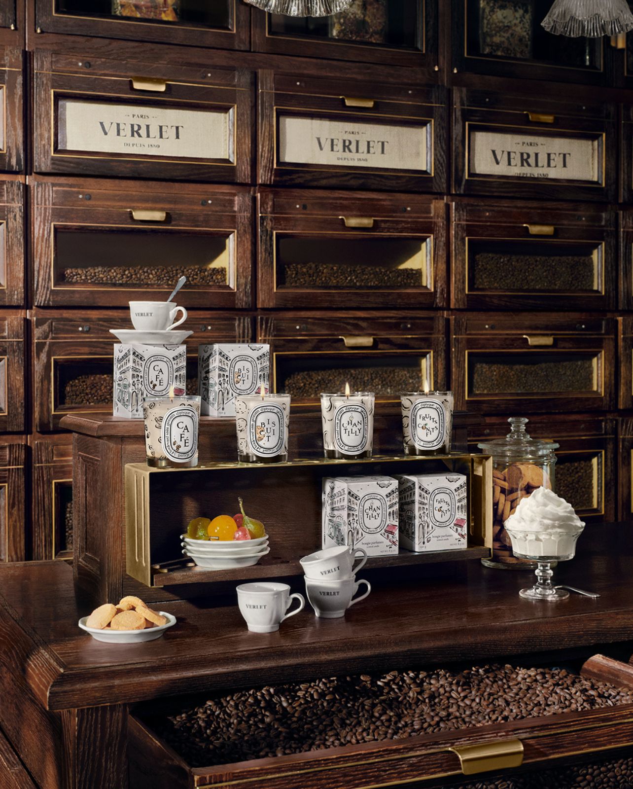 Brown cabinet filled with Diptyque coffee and candle products