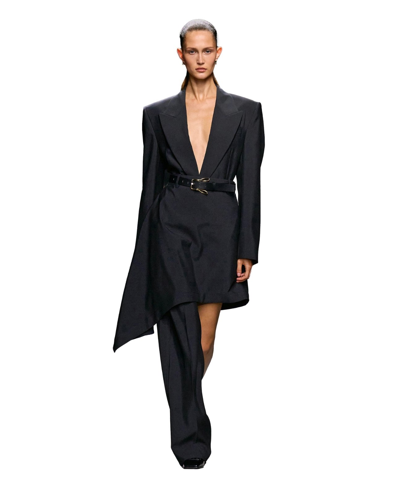 Bottega Veneta on model wearing a black asymmetrical belted skirt over black one-leg pants