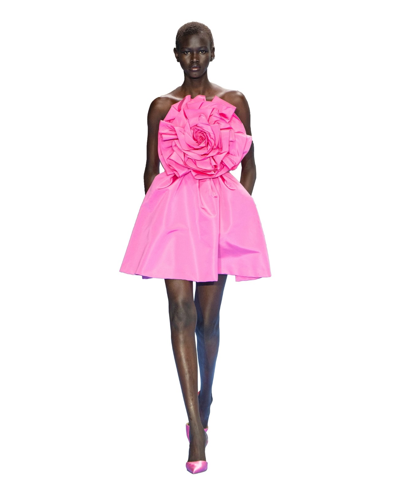 Carolina Herrera on model wearing an oversized pink ruffled top and skirt