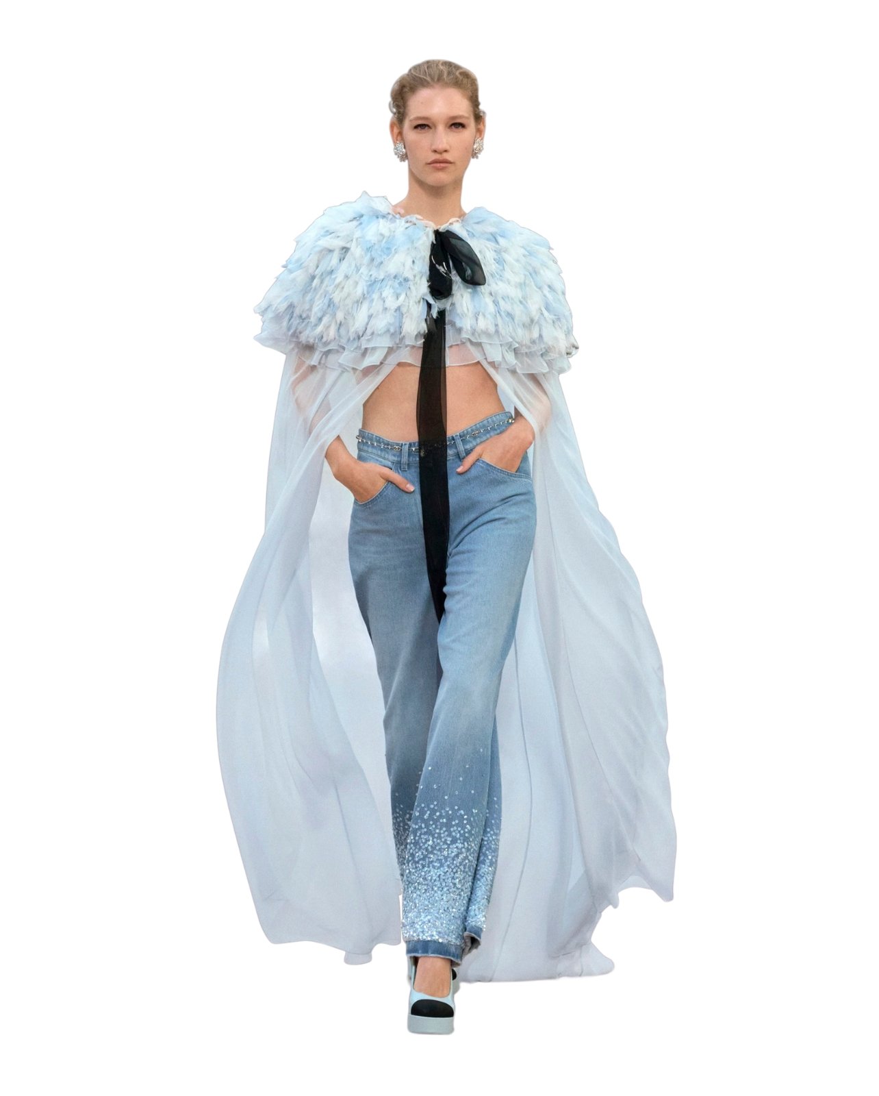 Chanel model wearing a light blue silk mousseline embroidered with feathers and jeans with rhinestones