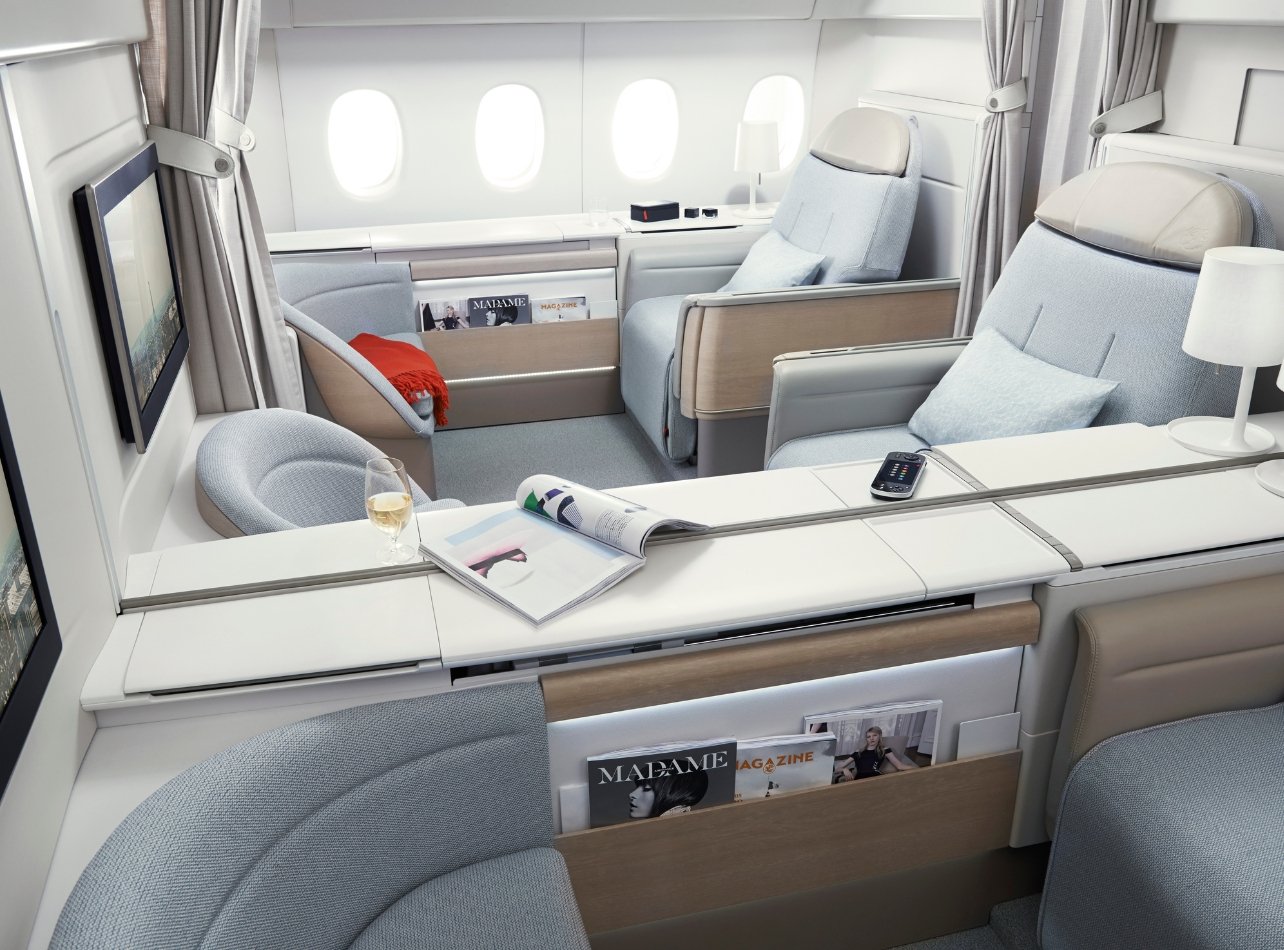 Air France’s La Premiere cabin with gray reclining seats, TV screens and magazine