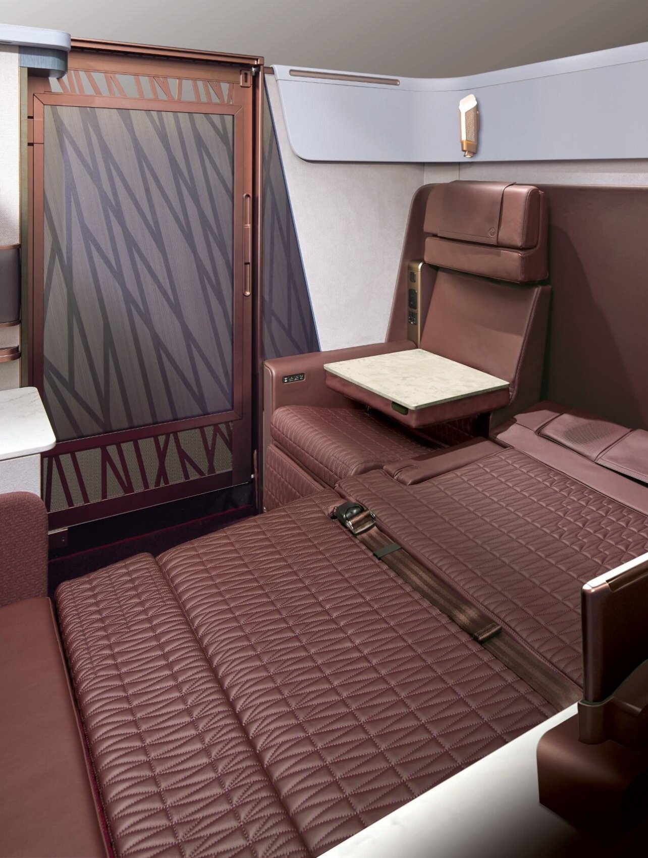 Photo of a JAL Airlines cabin with brown leather bedding and seating