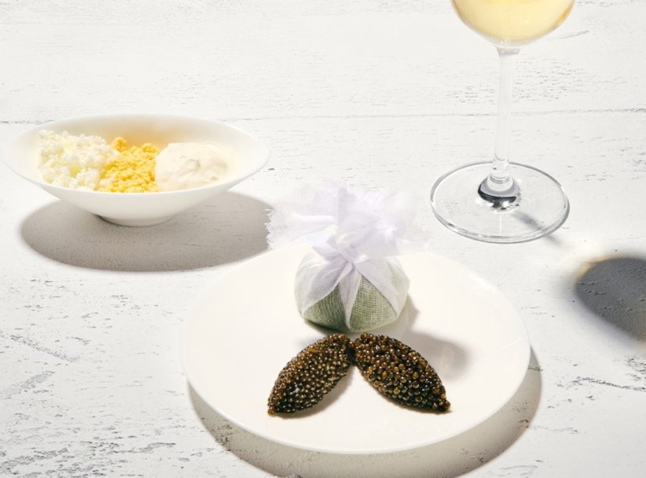 Plate of Caviar, Bowl of hardboiled egg and a glass of champagne