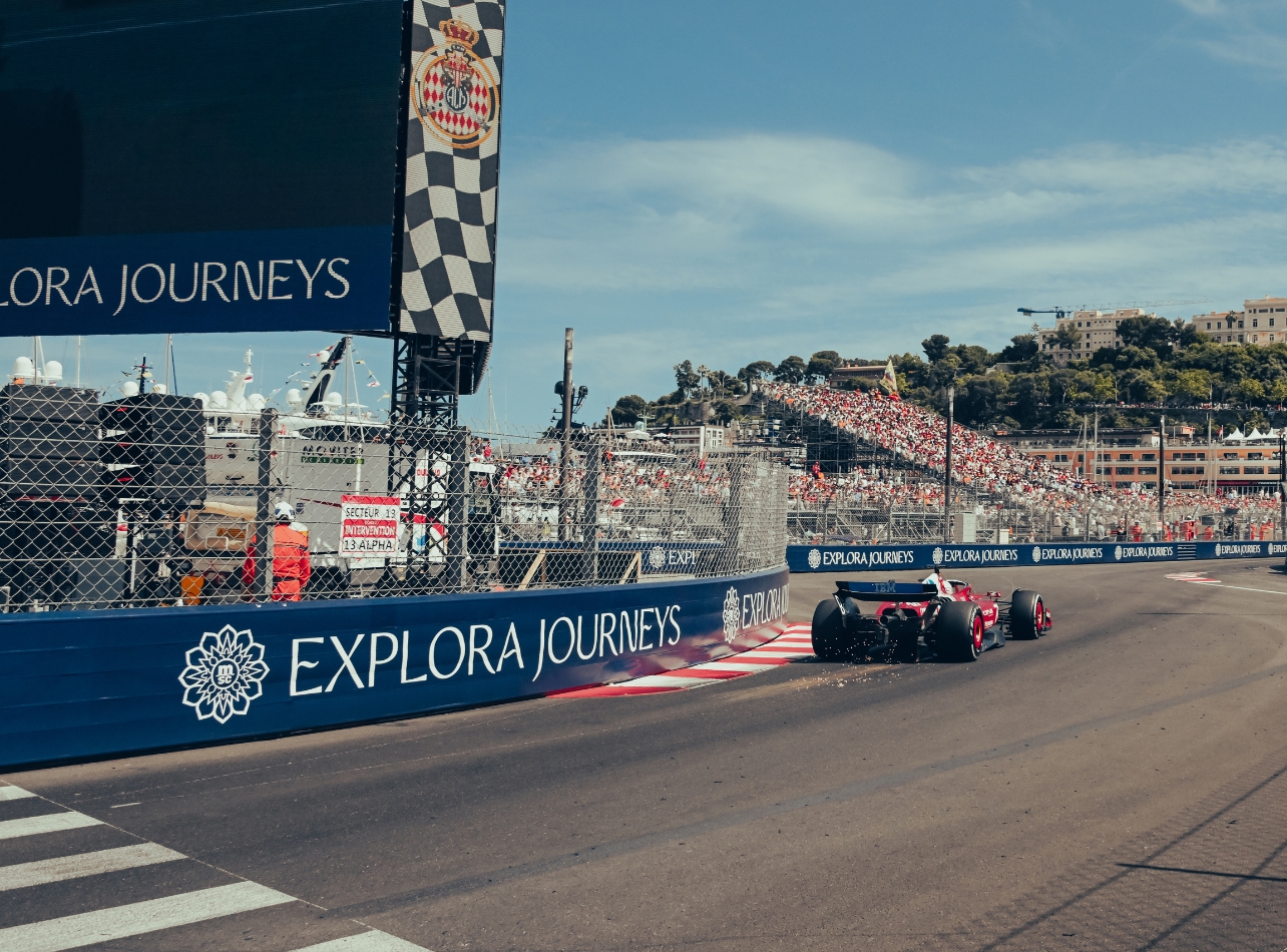 Racetrack with race car with Explora Journeys logo on track