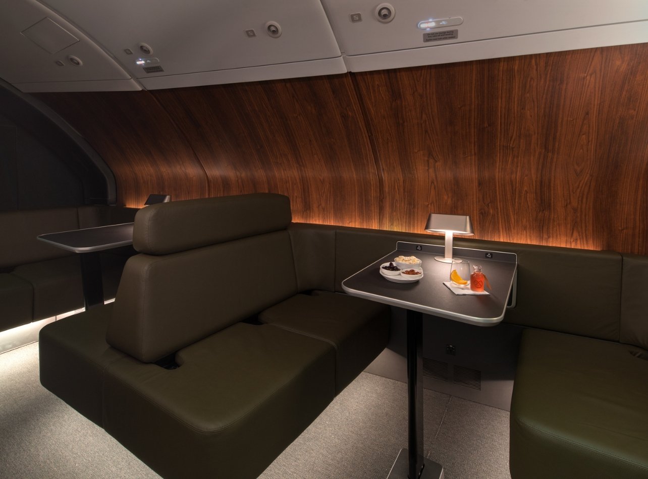 Qantas A380 onboard lounge with table with beverage and food