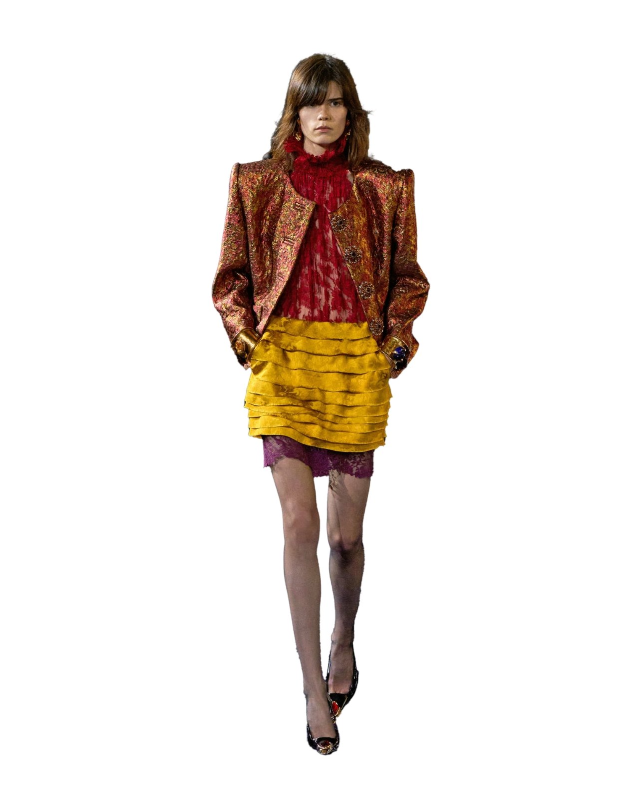 Saint Laurent on model wearing a bronze color opulent brocade jacket and textured layers of colorful lace and silk