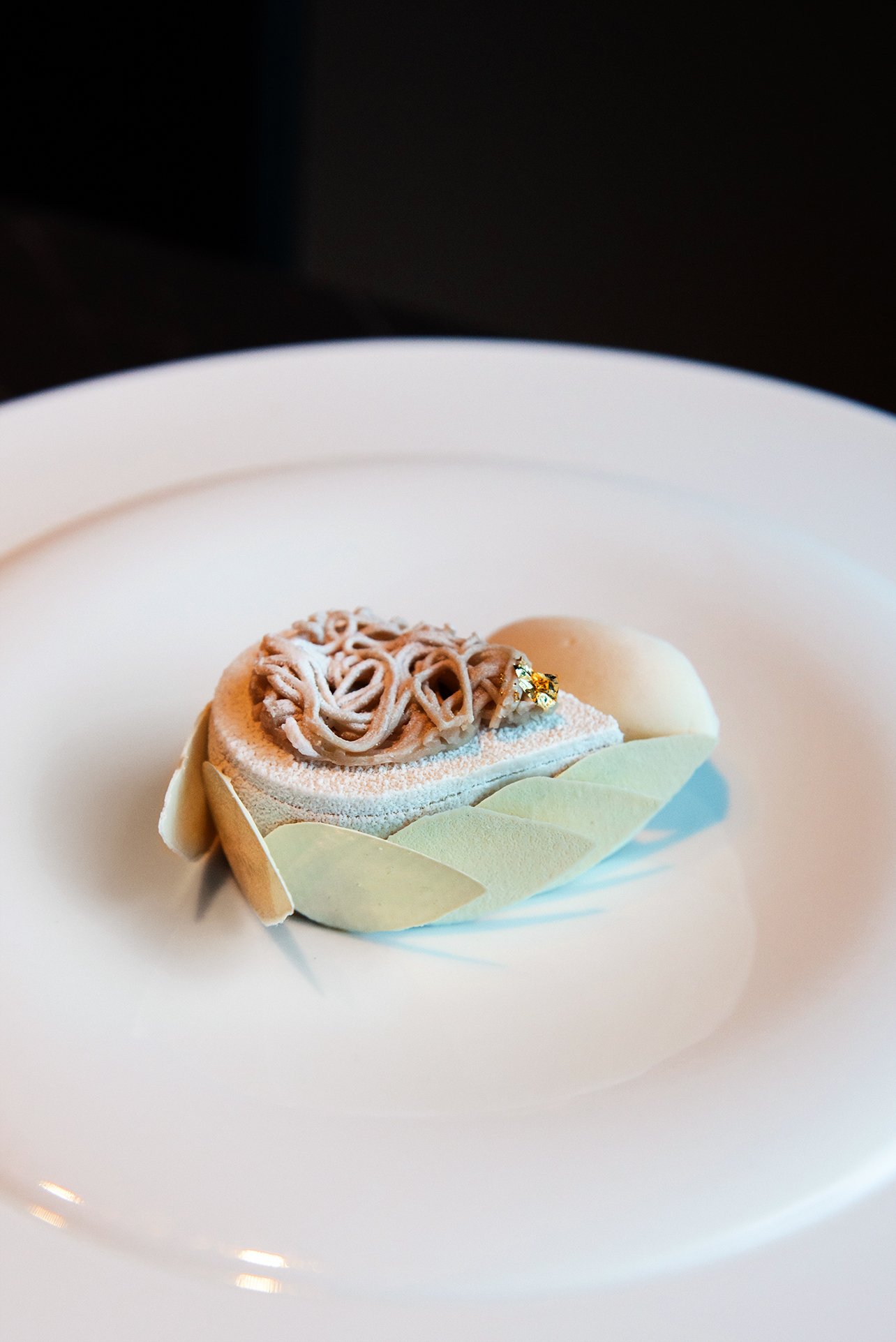A close-up of a dish at Cyrus Restaurant featuring a Mont Blanc cake made with chestnuts, candy cap mushrooms, and parsnips