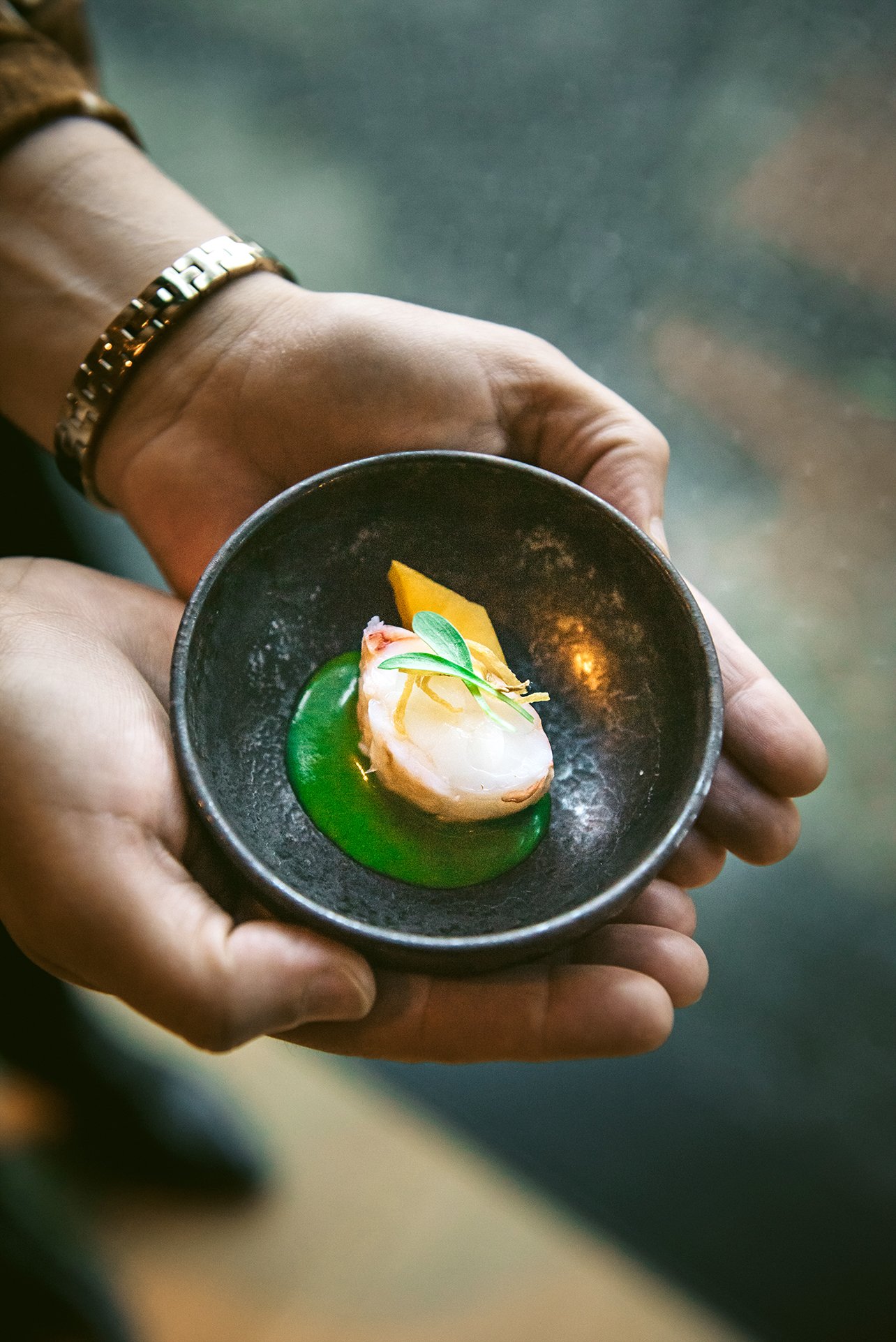 A close-up of a dish at Cyrus Restaurant featuring lobster with avocado and a Thai basil dressing