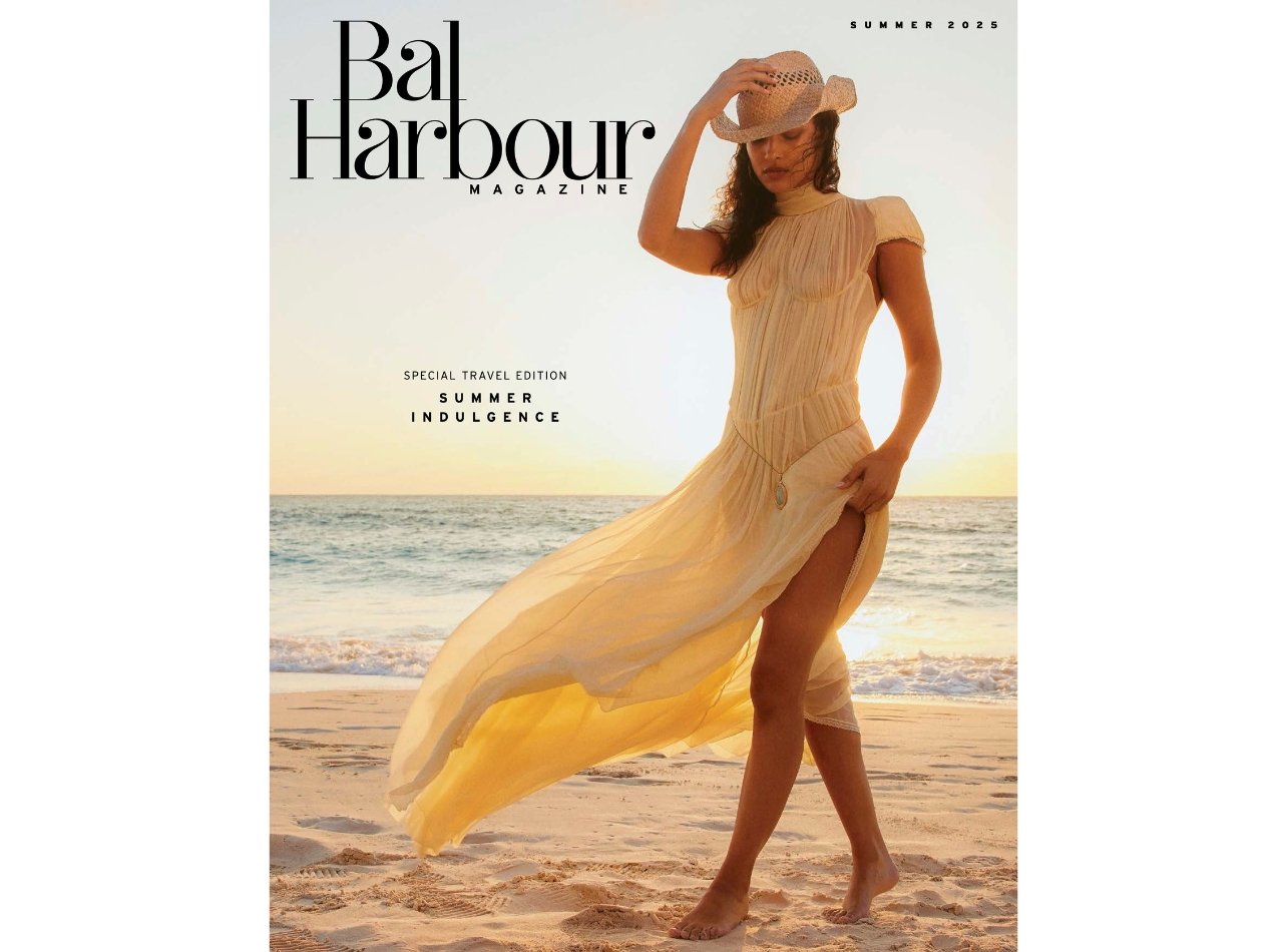 Fashion model in a flowy sheer dress and a straw cowboy hat on the beach