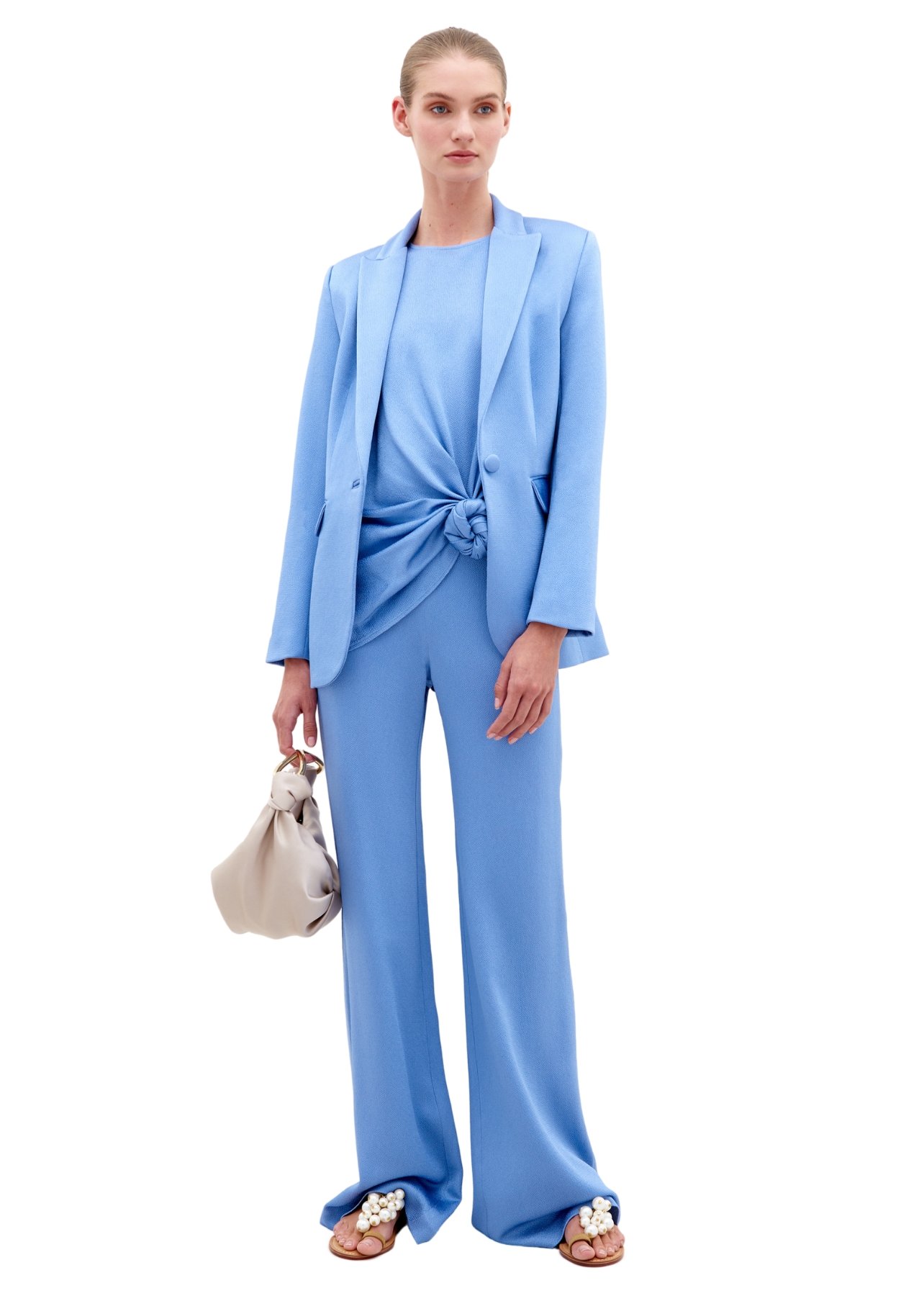 Silvia Tcherassi model wearing a matching blue blazer, top, and pants