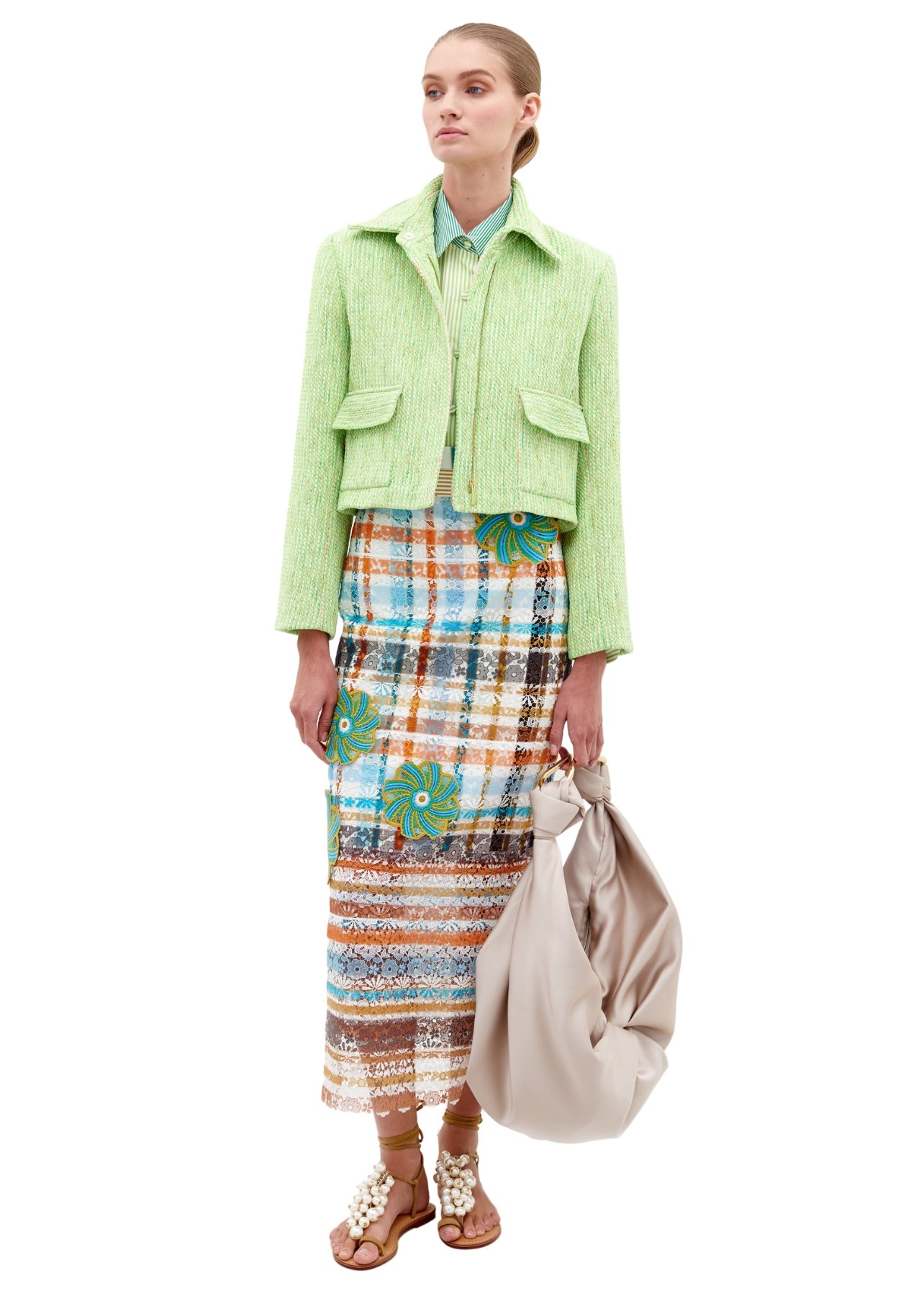 Silvia Tcherassi model wearing a green jacket paired with a colorful striped floral skirt