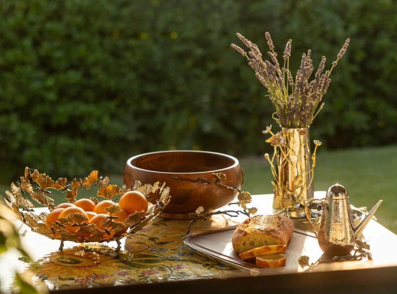 Table outside with Michael Aram bowls and pitcher with loaf of bread