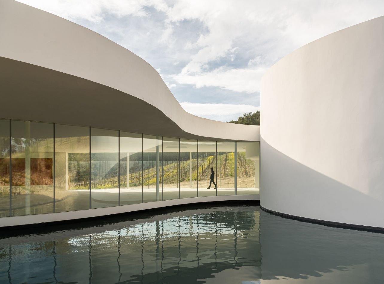 white house with glass windows above water