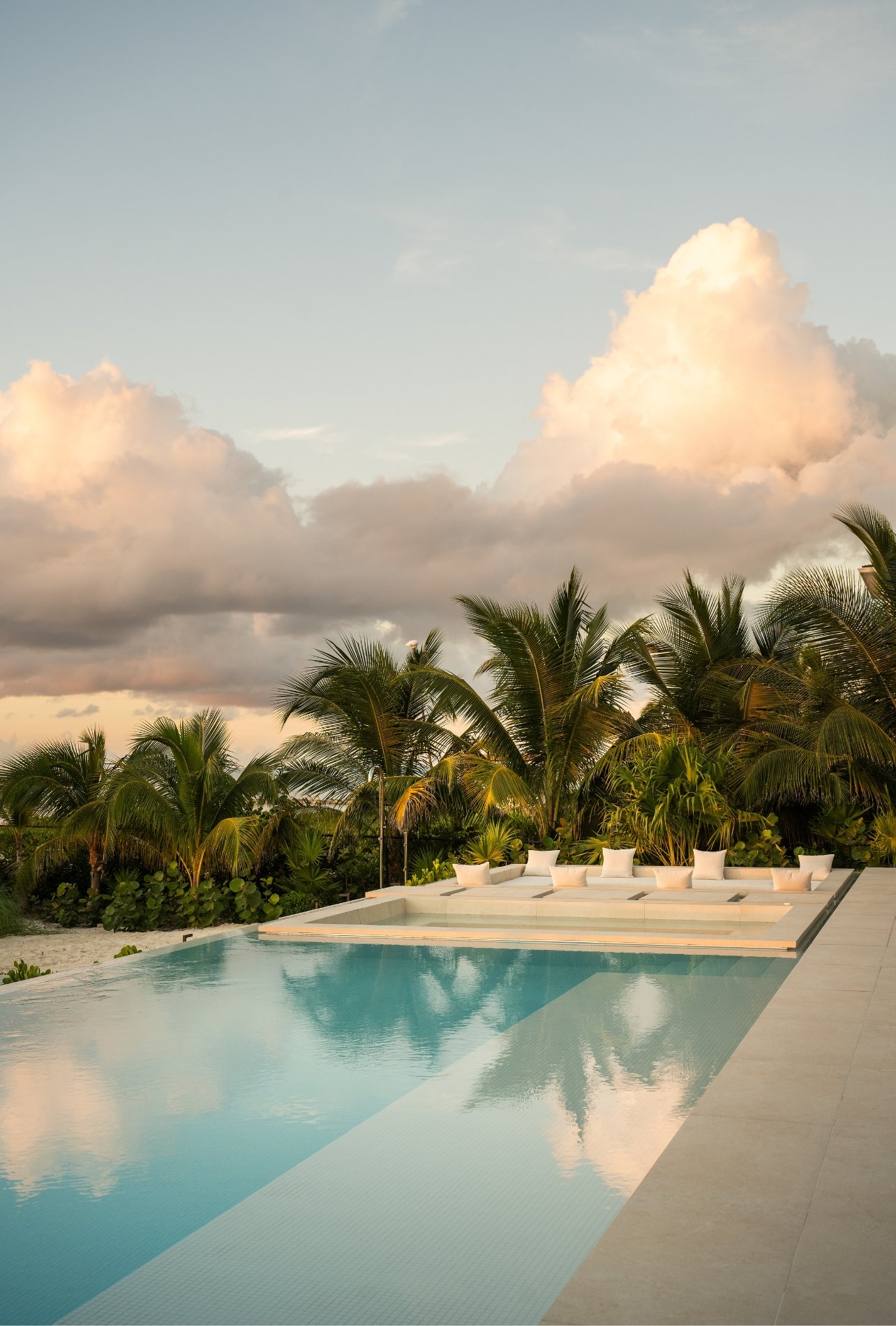 A view of the infinity pool during golden hour at The Reserve at Grace Bay by Beach Enclave