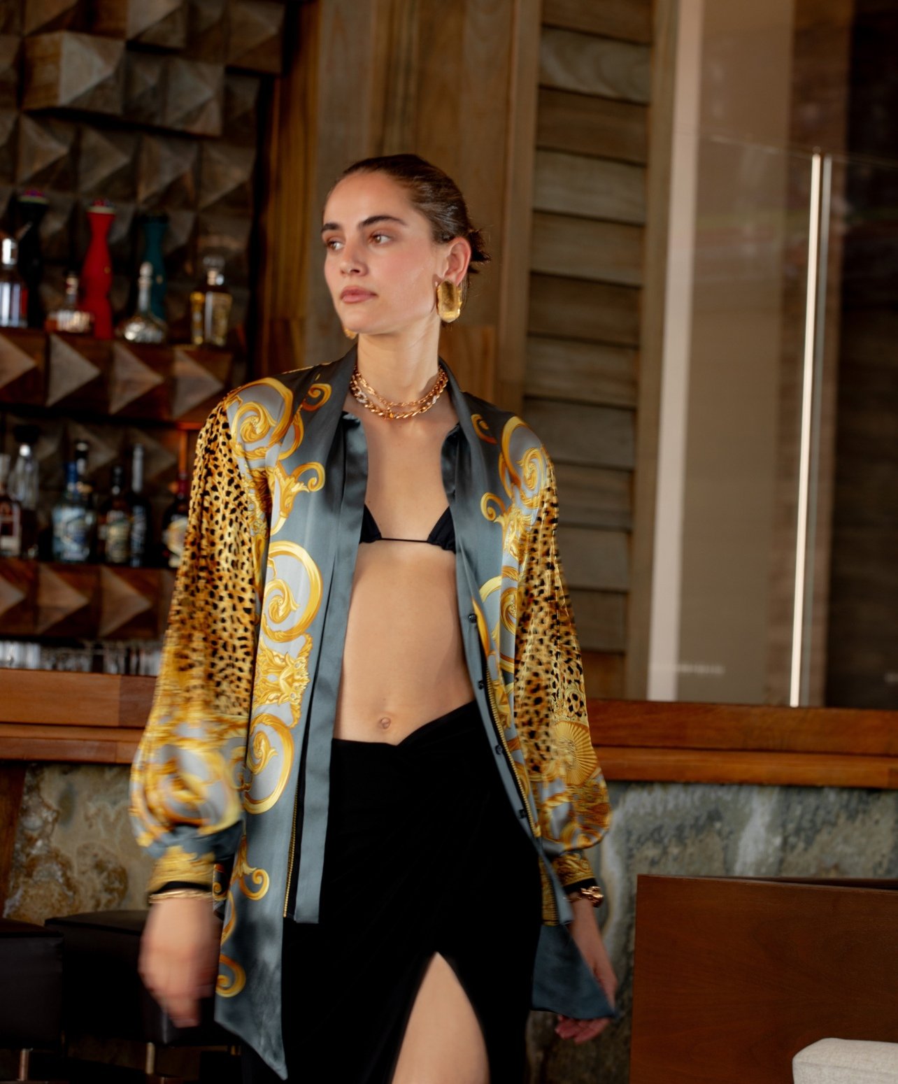 Fashion model with silk animal print top and bralette