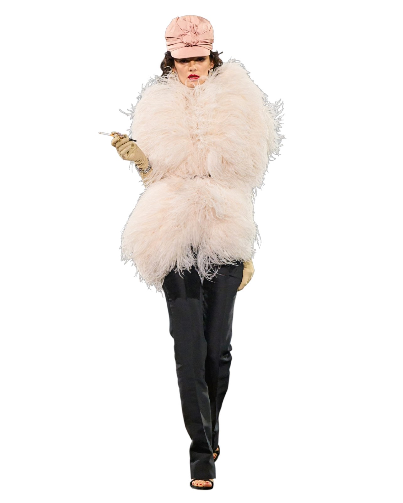 Runway model in a pink hat, white fur coat, and black pants