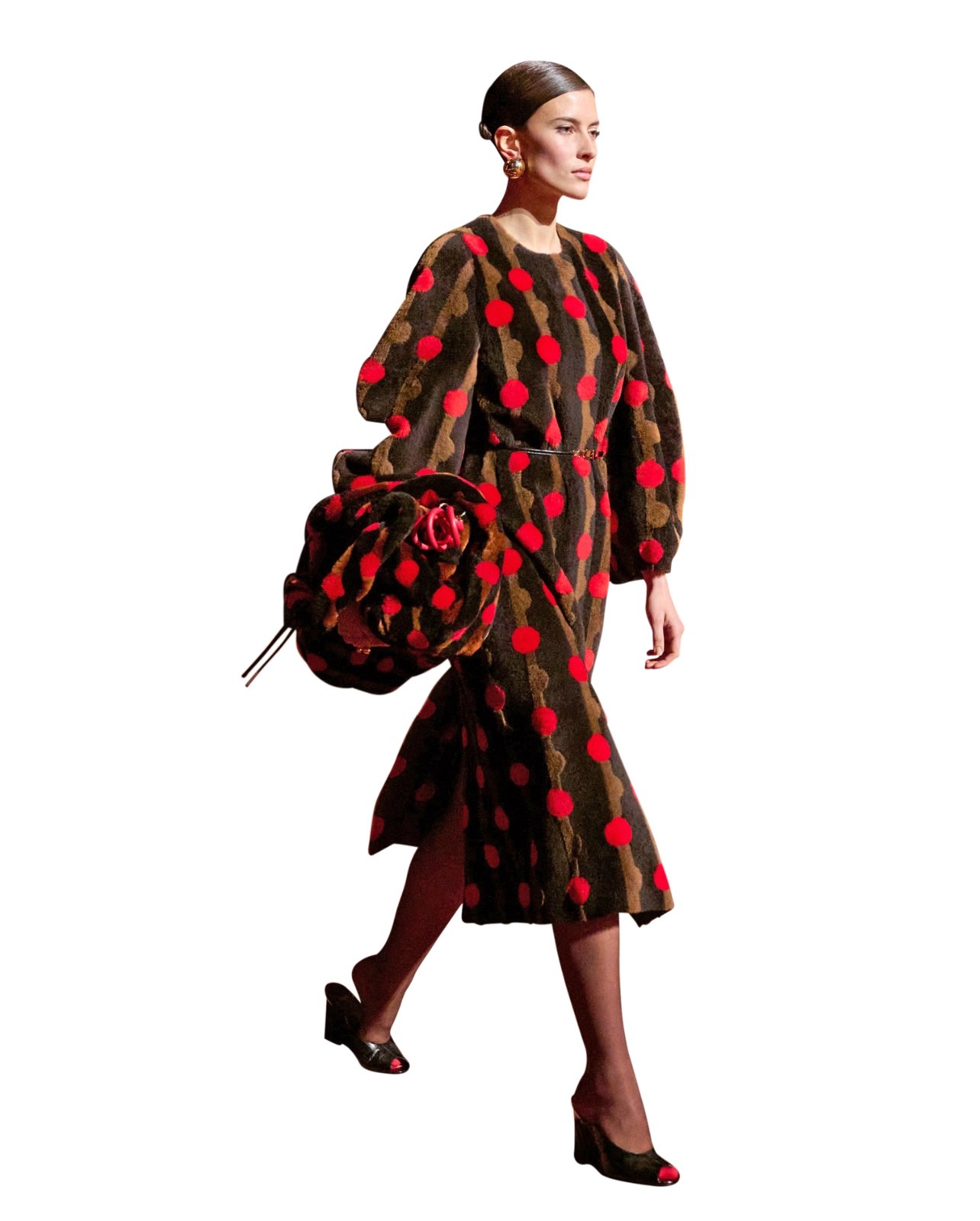 Runway model in a brown striped fur dress with puffy sleeves, red polka dots, and a matching purse
