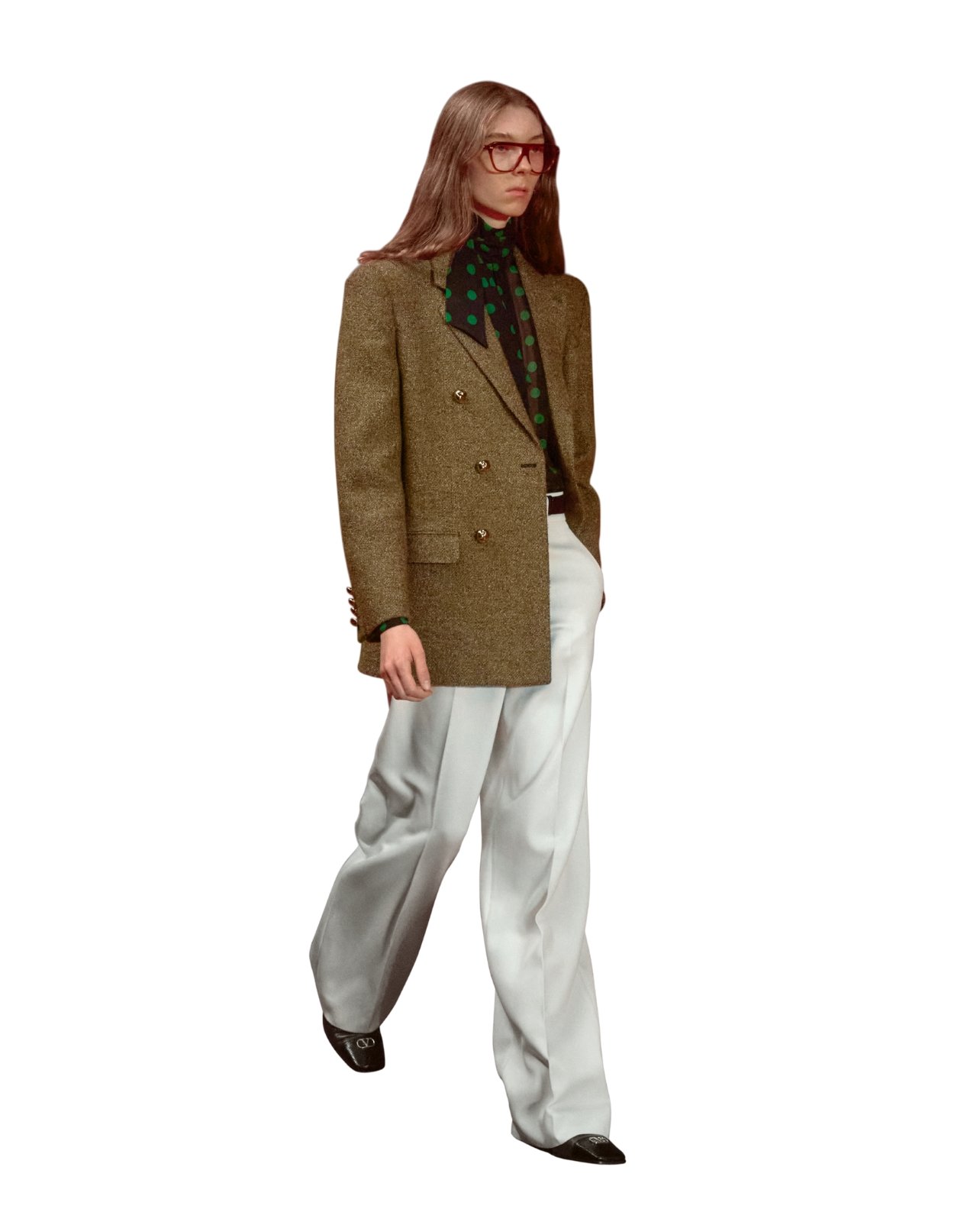 Valentino on model wearing a polka dot scarf, brown blazer, and tan slacks