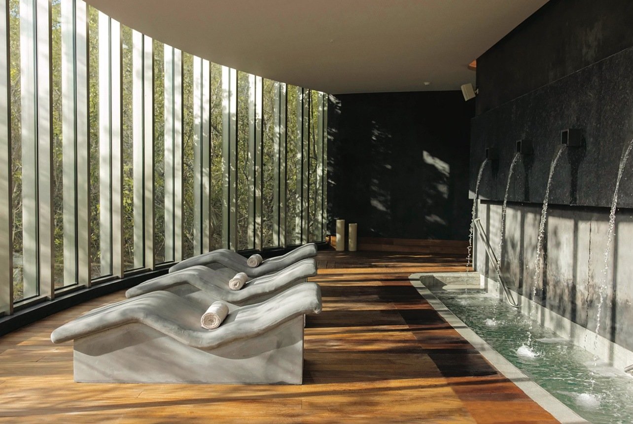 A room with spa lounge chairs in a hydrotherapy circuit treatment