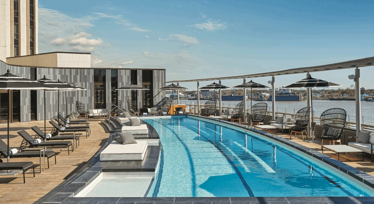 A pool deck at the Four Seasons hotel overlooking the water