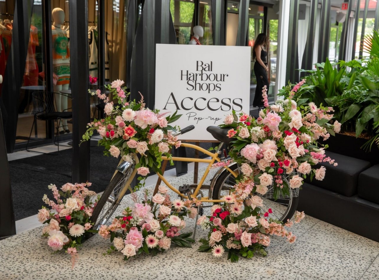 Bike with pink flowers all around it and sign that says Bal Harbour Shops Access Pop-up