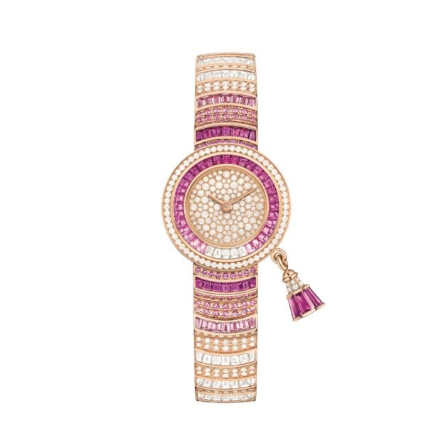 Van Cleef & Arpels pink and diamond watch with a small round face and charm accents