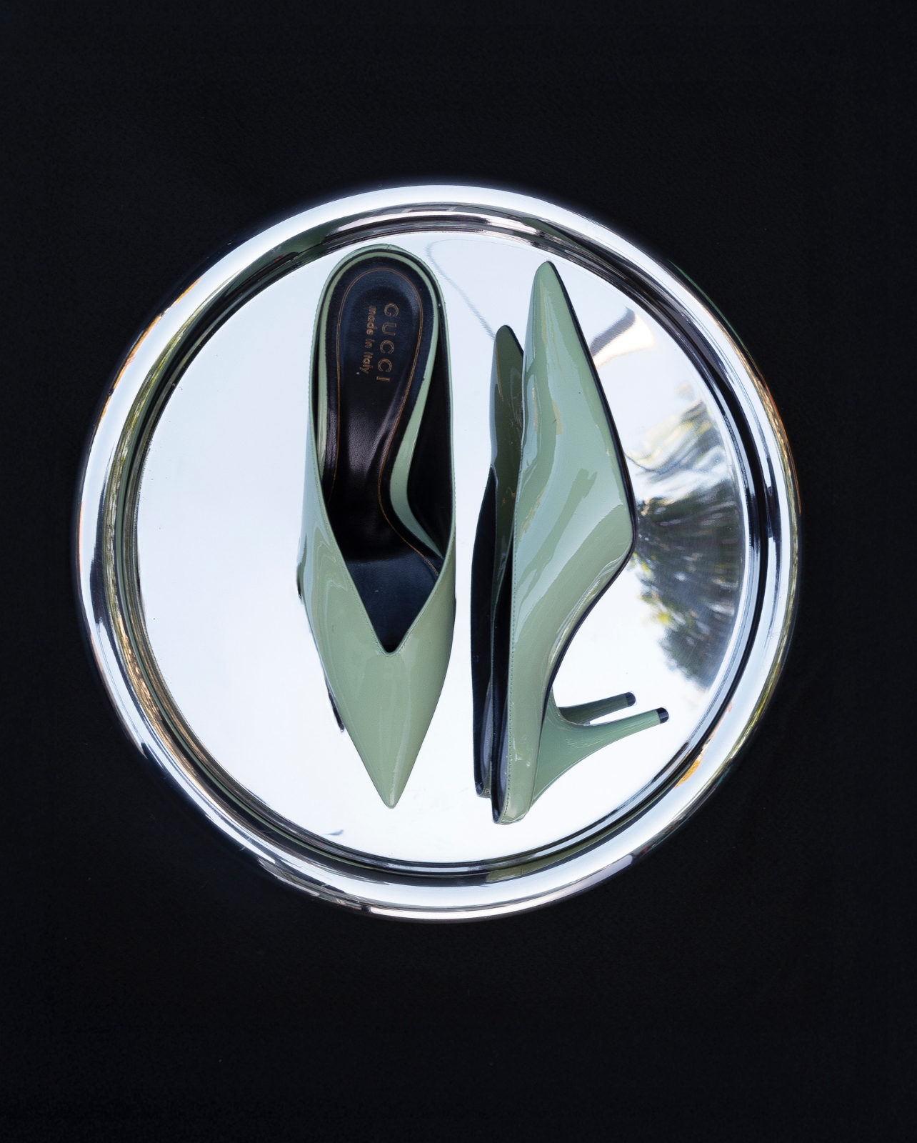 Gucci mint colored kitten heels photographed on a silver tray