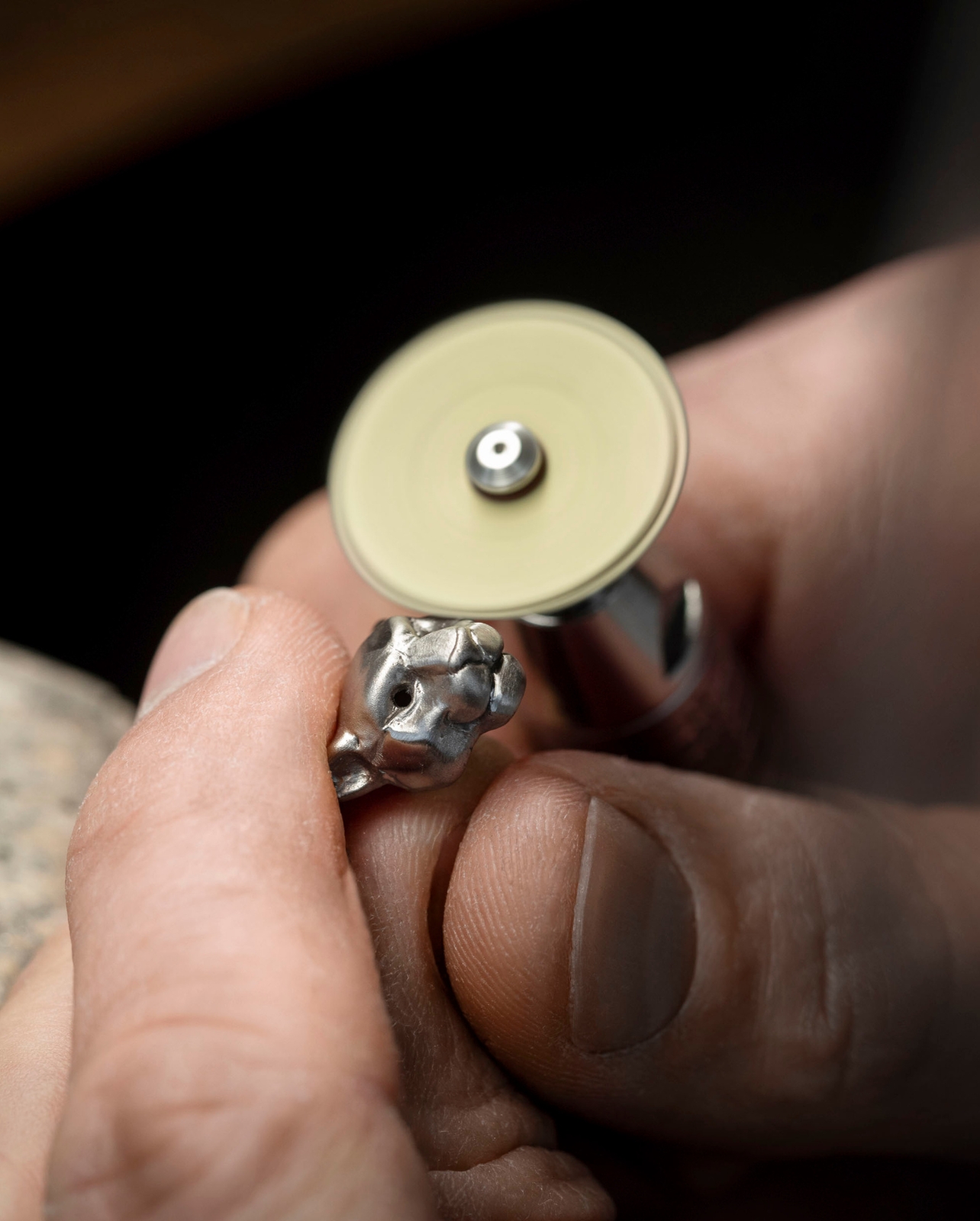 Hand welding a jaguar face into silver