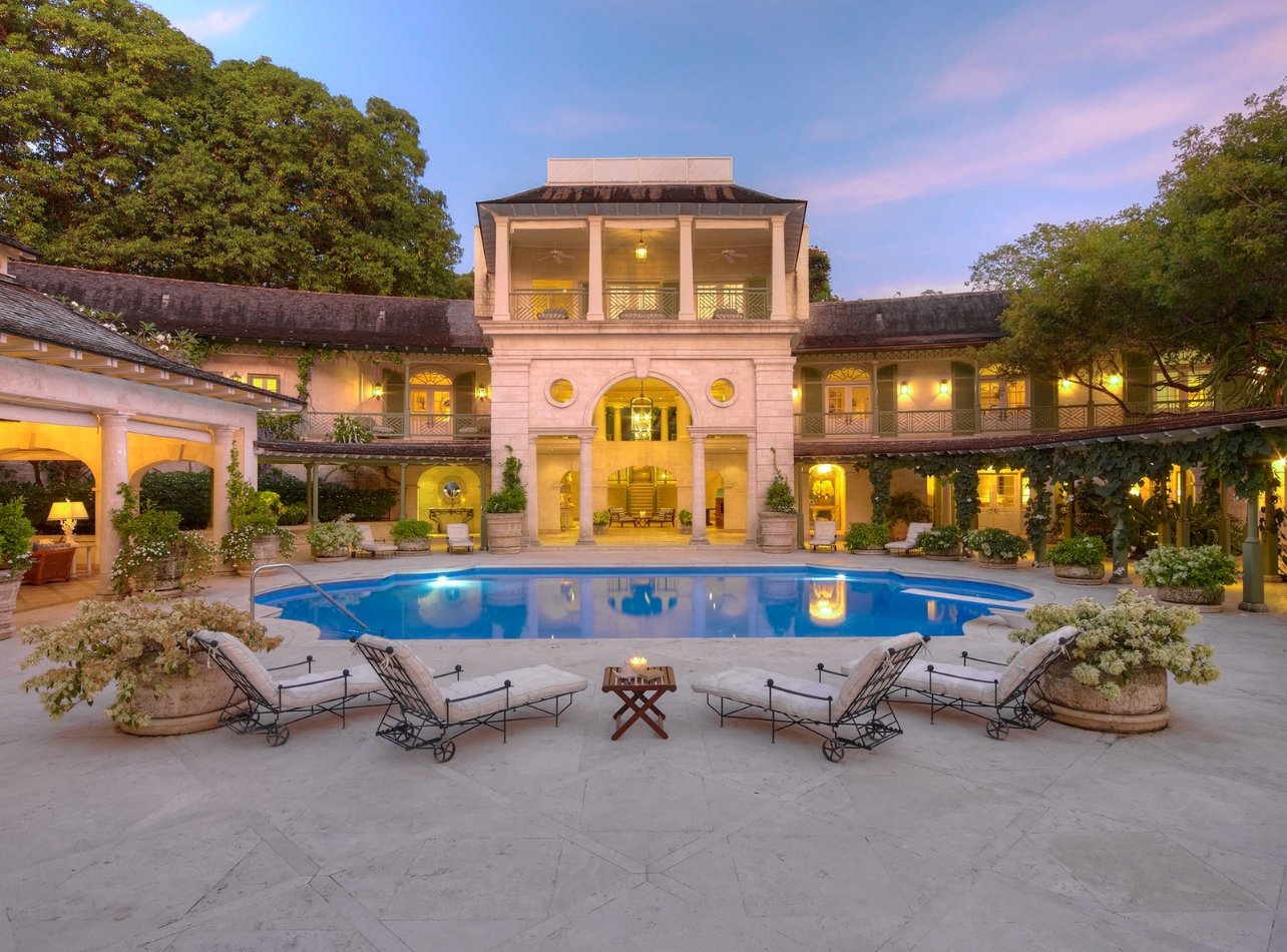 A pool shot in evening light with a view of a hotel courtyard