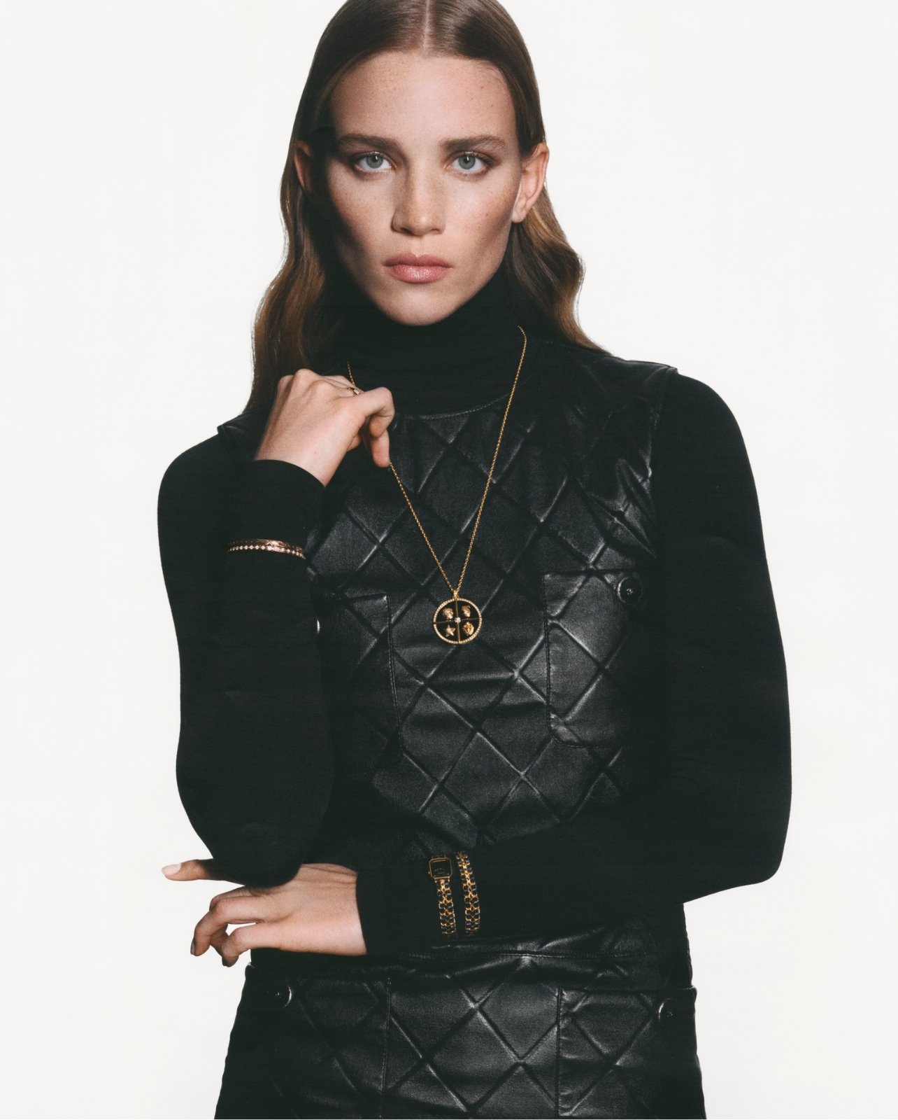 Chanel model wearing long sleeve black shirt with jewelry