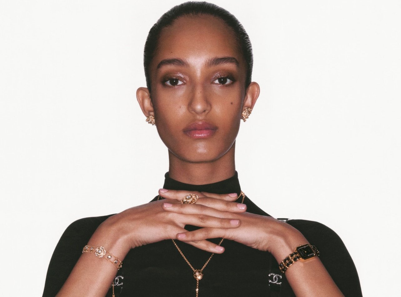 Chanel model wearing a short sleeve black shirt with jewelry