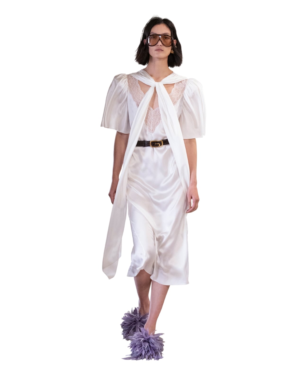 Gucci runway model wearing a white silk dress and purple furry shoes