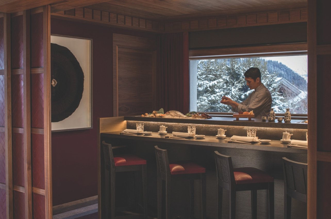 Interior restaurant with a chef preparing sushi